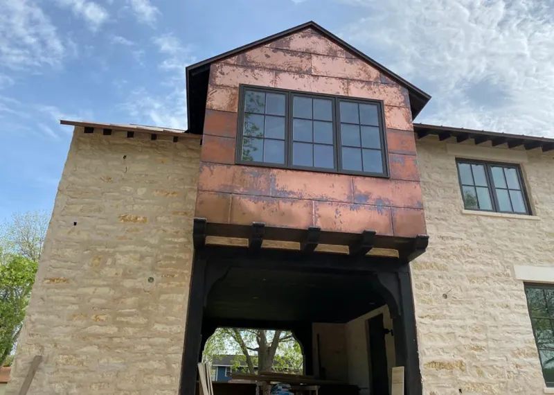 Copper metal panel facade on a stone building for Skylight Installation in Selma